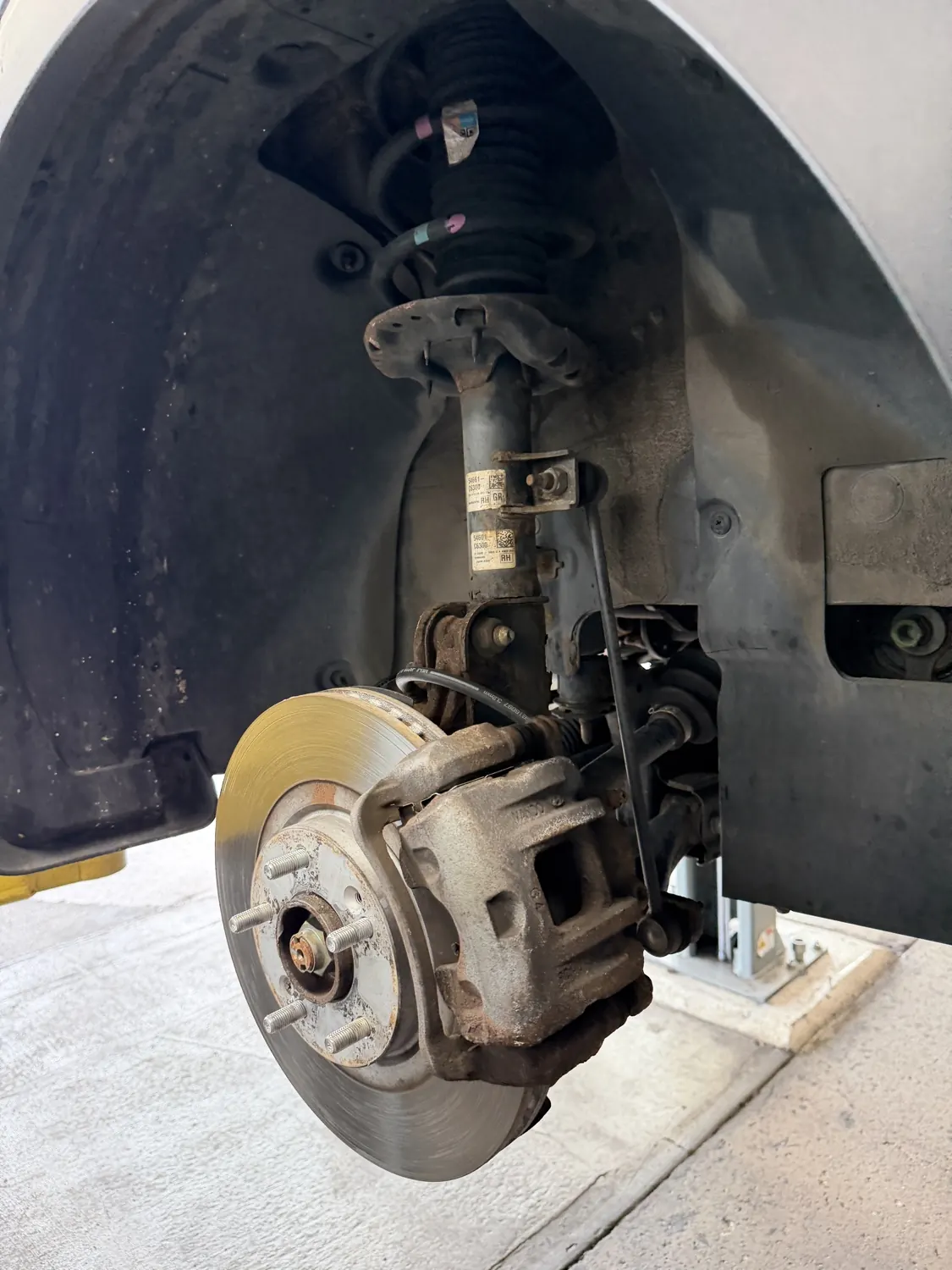 Strut, coil spring and suspension corner exposed at KRP Automotive Repair in Clifton, NJ