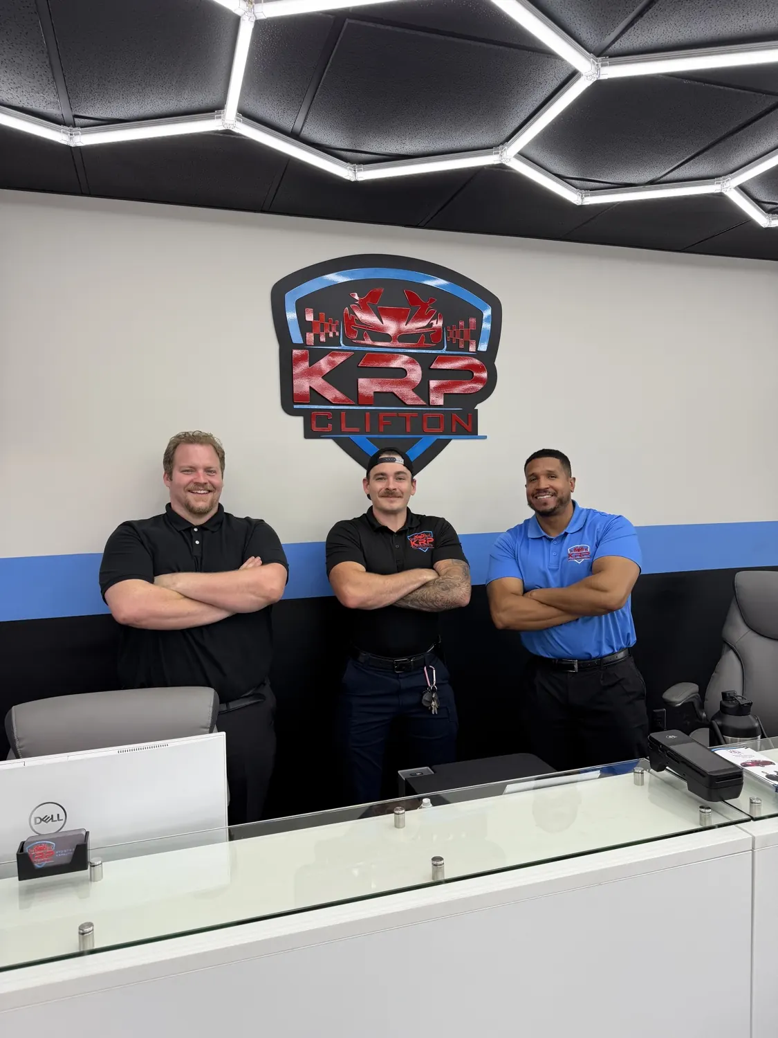 Three KRP Automotive team members at the Clifton front desk