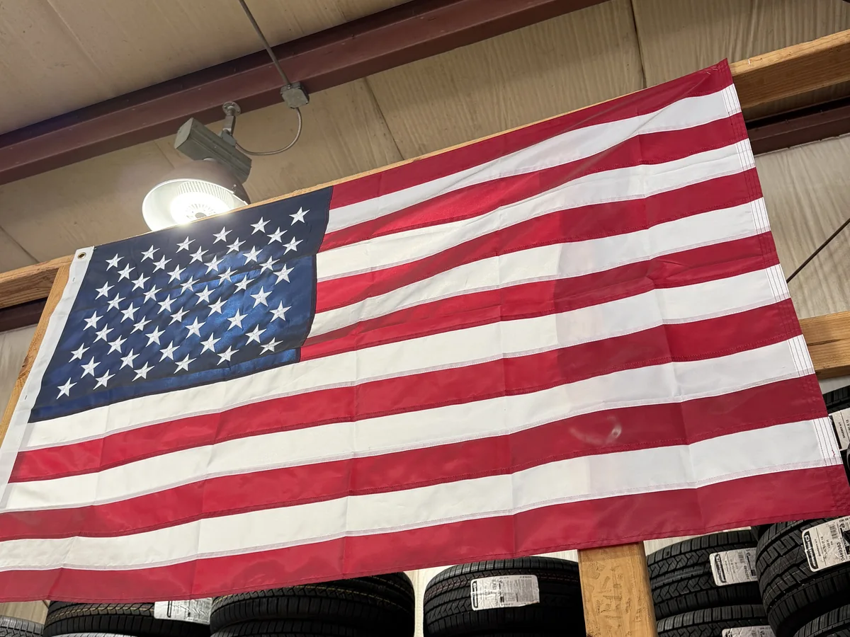 The American flag hanging over the tire racks at KRP Automotive Repair in Franklin, New Jersey