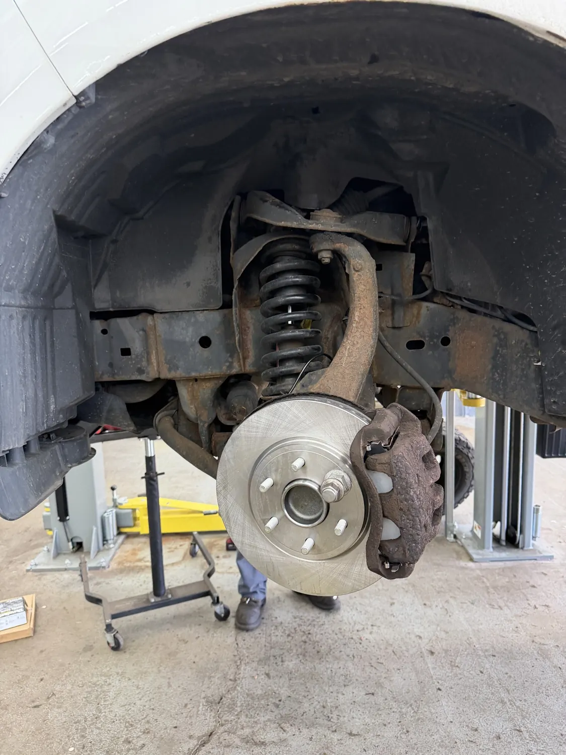 Strut, coil spring and suspension corner exposed at KRP Automotive Repair in Hawthorne, NJ